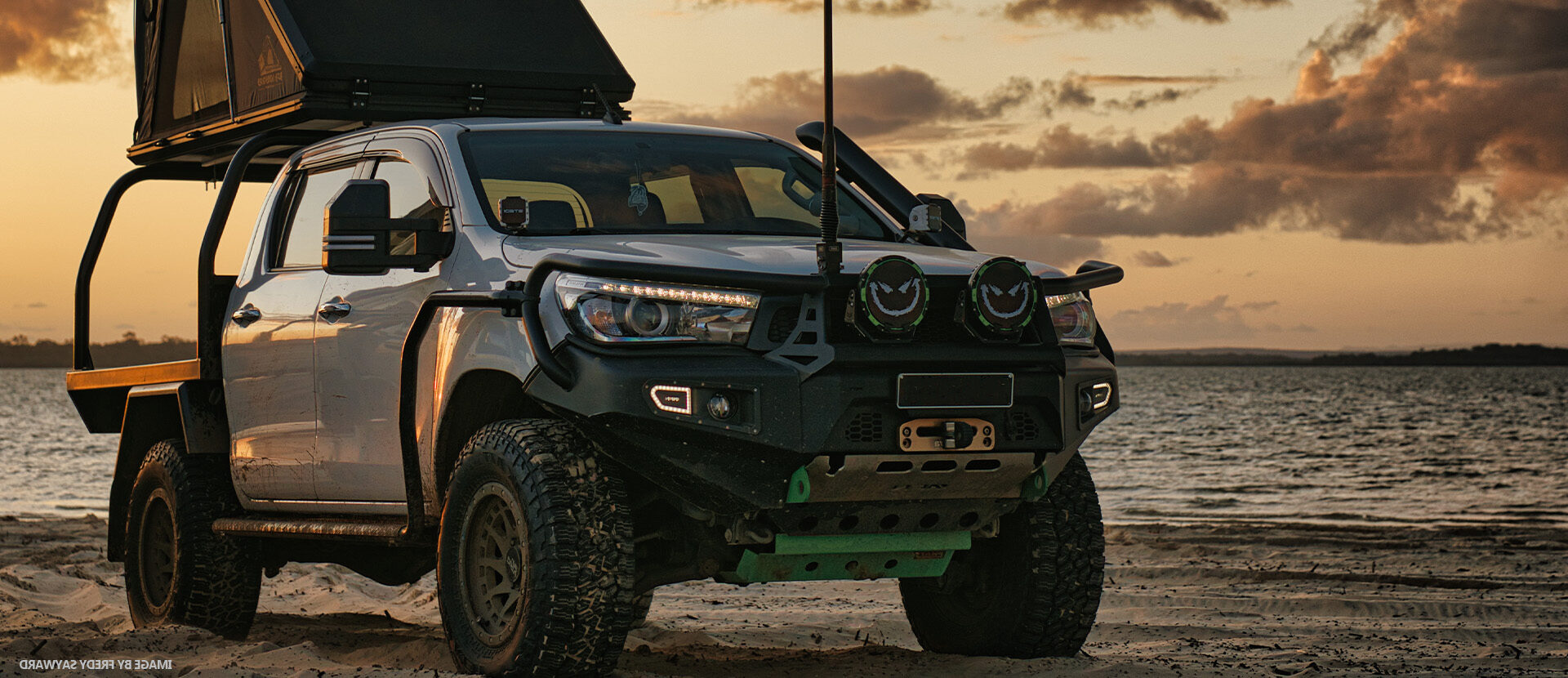 Dirty Life vehicle at sunset orange beach